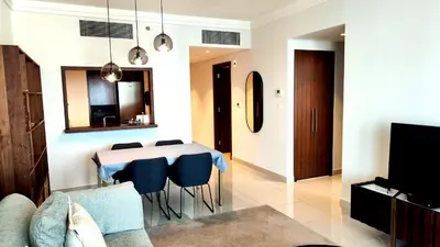 a living room with a table and chairs and a tv at 