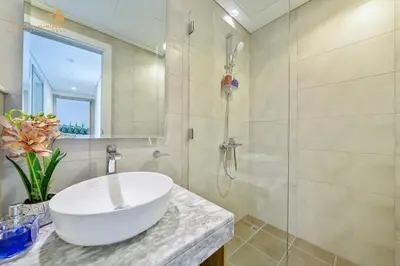 a bathroom with a white sink and a shower at Luxury Sea View High Floor 3Bhk in Dubai