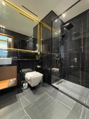 a bathroom with a shower and a toilet and a sink at Elegant 2br Jvc Private Pool, Balcony & Parking in Dubai