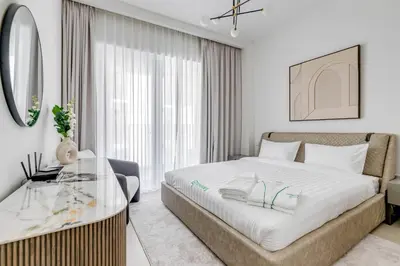 a bedroom with a bed and a glass table at Knokey Dubai Creek Beach with Lagoon Pool access in Dubai