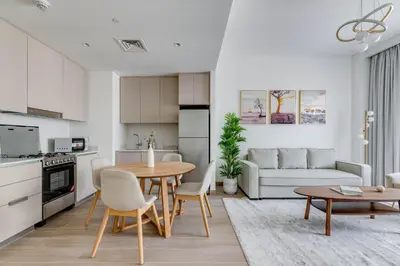 a kitchen and living room with a table and chairs at Knokey Dubai Creek Beach with Lagoon Pool access in Dubai