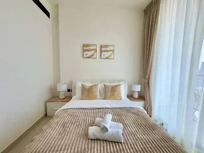 a bedroom with a bed with a white towel on it at Modern 1br In Jvc Balcony, Pool & Parking in Dubai