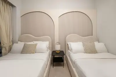 two beds sitting next to each other in a bedroom at FIRST CLASS 2BR Burj Khalifa & Fountain view in Dubai
