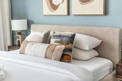 a white couch with pillows on top of it at GuestReady - Sky-High Luxury with a Private Pool in Dubai