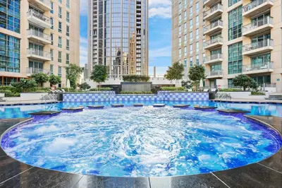 a large pool in a city with tall buildings at FIRST CLASS 2BR Spectacular Fountain Views in Dubai