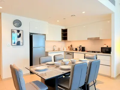 a kitchen and dining room with a table and chairs at 2 bedroom apartment infront of Dubai mall by Aventine homes in Dubai