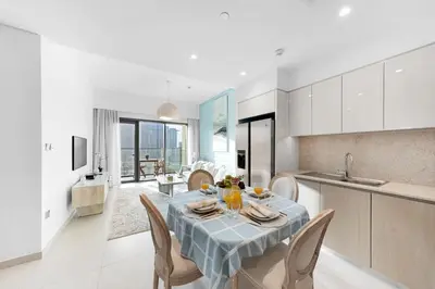 a kitchen and dining room with a table and chairs at Burj Royale Lux 2-bedroom apartment with the best Burj Khalifa view in Dubai