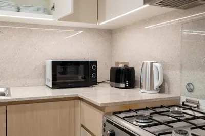 a kitchen with a stove and a microwave at Burj Royale Lux 2-bedroom apartment with the best Burj Khalifa view in Dubai