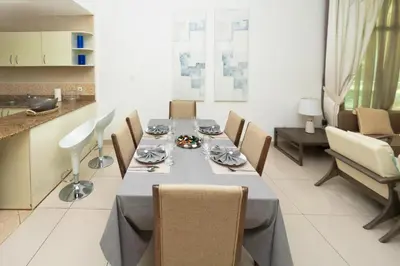 a dining room with a long table and chairs at 2 Bed in Atlantic Tower 2 by PK Holidays in Dubai
