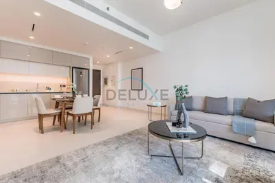 a living room with a couch and a table at Dubai Harbour & Sea Views 1 BR Near Key Landmarks, Marina Vista T1, Emaar Beachfront by Deluxe Holiday Homes in Dubai