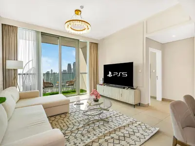 a living room with a couch and a tv at Brand New! Downtown views located on Dubai Mall in Dubai