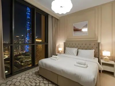a bedroom with a large window with a city skyline at Brand New! Downtown views located on Dubai Mall in Dubai