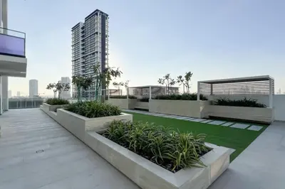 a balcony of a building with plants on it at Large New Apartment Pool in JVC Community in Dubai