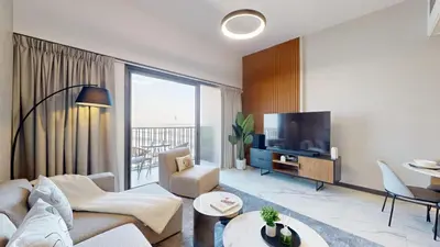 a living room with a couch and a tv at Mag Eye 890 - Airy One Bedroom in Meydan in Dubai