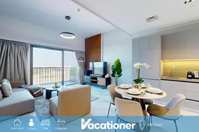 a living room with a table and chairs and a kitchen at Mag Eye 900 - One Bedroom with Downtown Dubai View in Dubai