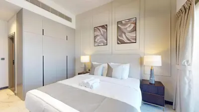 a bedroom with a large white bed with two pillows at Mag Eye 900 - One Bedroom with Downtown Dubai View in Dubai