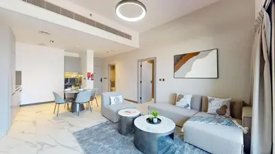 a living room with a couch and a table at Mag Eye 900 - One Bedroom with Downtown Dubai View in Dubai