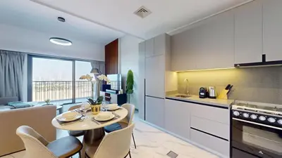 a kitchen and living room with a table and chairs at Mag Eye 900 - One Bedroom with Downtown Dubai View in Dubai