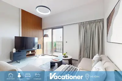 a living room with a couch and a tv at Mag Eye 910 - Magnificent One Bedroom in Meydan in Dubai