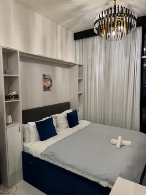 a bedroom with a bed with a teddy bear on it at Bayz Business Bay Lux Studio with Resort Amenities in Dubai