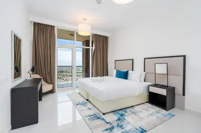 a bedroom with a bed and a view of the ocean at Ahlan HH - Luxury 2BR Damac Tower 108 at High Floor in Dubai