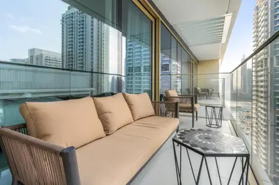 a living room with a couch on a balcony at Luxury 2BR at Grand Bleu in Dubai