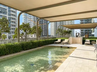 an indoor pool in a building with a patio at Luxury 2BR at Grand Bleu in Dubai