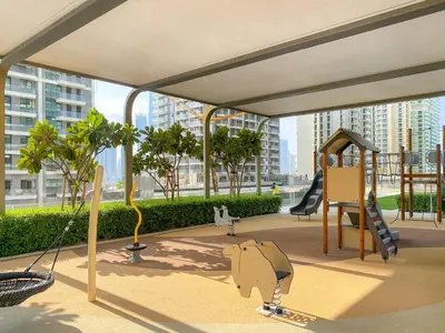 a play area with a playground in a building at Luxury 2BR at Grand Bleu in Dubai