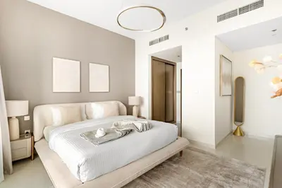 a white bedroom with a bed with a tray on it at Luxury 2BR at Grand Bleu in Dubai