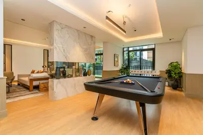 a living room with a pool table in it at Sleek & Modern 1BR with Luxury Pool in JVC in Dubai