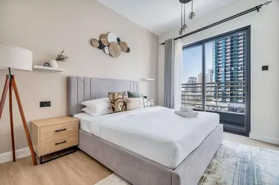 a bedroom with a large bed and a large window at GuestReady - Beautiful home in the JLT area in Dubai