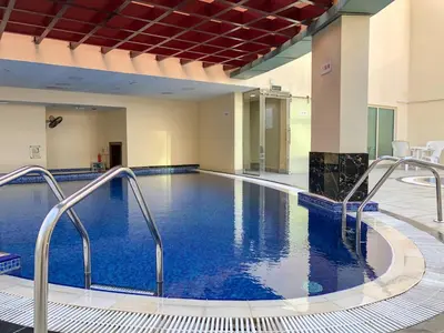 a large pool with blue water in a building at GuestReady - Beautiful home in the JLT area in Dubai