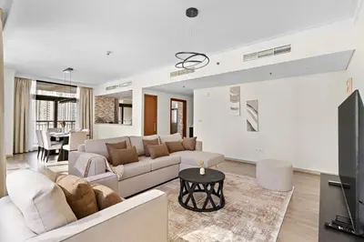 a living room with a couch and a table at Stonetree - Spacious 2BR at Dubai Creek Residences in Dubai