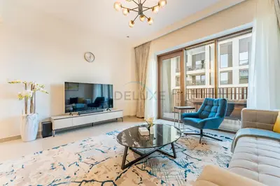 a living room with a couch and a tv at Community View 2BR with Balcony, Surf at Creek Beach Building 2, Creek Harbour by Deluxe Holiday Homes in Dubai