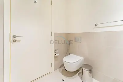a bathroom with a toilet and a glass door at Community View 2BR with Balcony, Surf at Creek Beach Building 2, Creek Harbour by Deluxe Holiday Homes in Dubai
