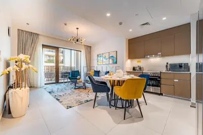 a kitchen and dining room with a table and chairs at Community View 2BR with Balcony, Surf at Creek Beach Building 2, Creek Harbour by Deluxe Holiday Homes in Dubai