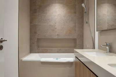 a bathroom with a bath tub and a sink at Bellavista - 2 Bedroom Downtown Views II T2 in Dubai