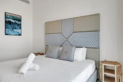 a bedroom with a large bed with white sheets and pillows at Bellavista - 2 Bedroom Downtown Views II T2 in Dubai