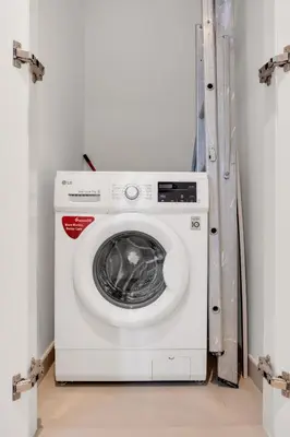a white washing machine sitting in a room at Bellavista - 2 Bedroom Downtown Views II T2 in Dubai