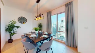 a dining room with a table and chairs and a large window at Paloma - Three Bed with Mesmerizing Marina View in Dubai
