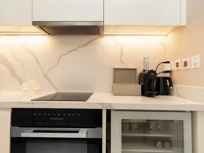 a kitchen with a counter top with a stove top oven at FIVE luxe JBR - High Floor Studio - Pool & Beach Access - Ventura Stays in Dubai