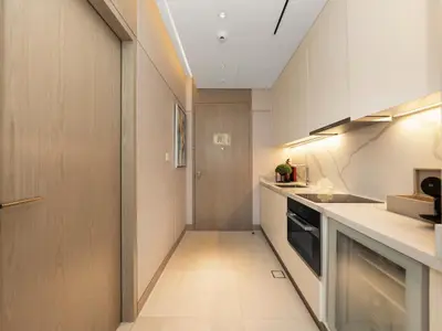 a small kitchen with a sink and a stove at FIVE luxe JBR - High Floor Studio - Pool & Beach Access - Ventura Stays in Dubai