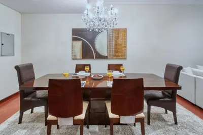 a dining room table with chairs and a chandelier at Dubai Marina, Beach & Marina View , 2 Bed Perfect for Groups in Dubai