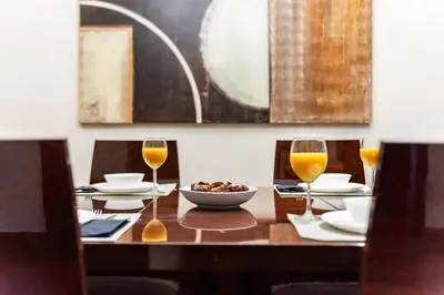 a wooden table with wine glasses and a bowl of food at Dubai Marina, Beach & Marina View , 2 Bed Perfect for Groups in Dubai