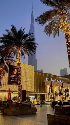 a city with two palm trees in front of a building at 5 minutes walk to Dubai mall and Burj Khalifa in Dubai
