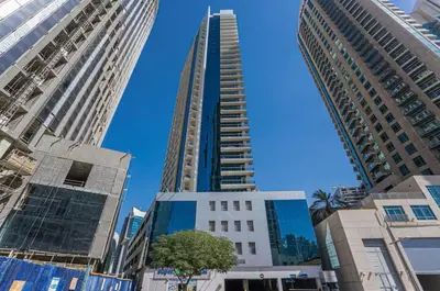 a group of tall buildings in a city at 5 minutes walk to Dubai mall and Burj Khalifa in Dubai