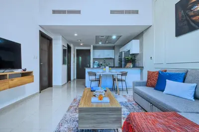 a living room with a couch and a table at Waterfront 1BR - Marina Views - Walk to Beach & Mall in Dubai