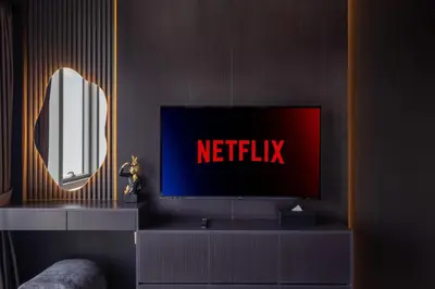 a tv sitting on a shelf with a netflix sign on it at Brand New LUXE Downtown Dubai 46th Floor in Dubai
