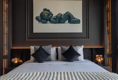 a bedroom with a bed with a picture on the wall at Brand New LUXE Downtown Dubai 46th Floor in Dubai