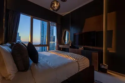 a bedroom with a large bed and a large window at Brand New LUXE Downtown Dubai 46th Floor in Dubai